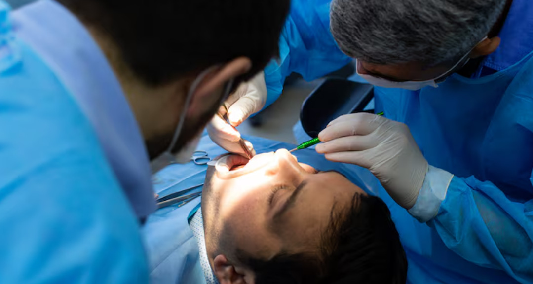 Dentists treating a patient during a tooth extraction Ormeau appointment